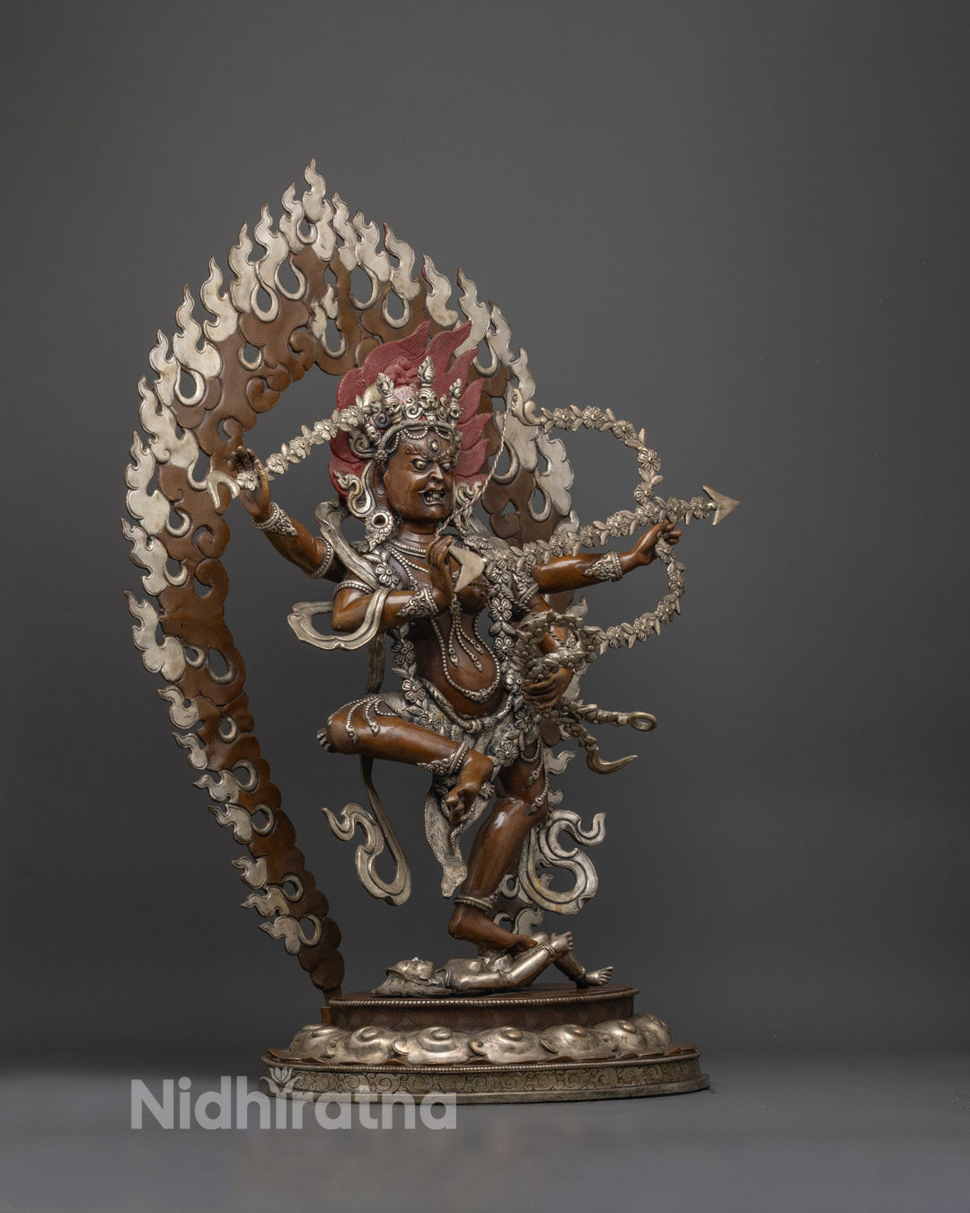 Close-up of oxidized copper face and silver-plated finish on Kurukulla statue