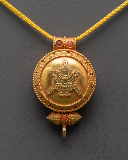 Close-up of sacred Bumpa design carved on gold-gilded Tibetan pendant locket

