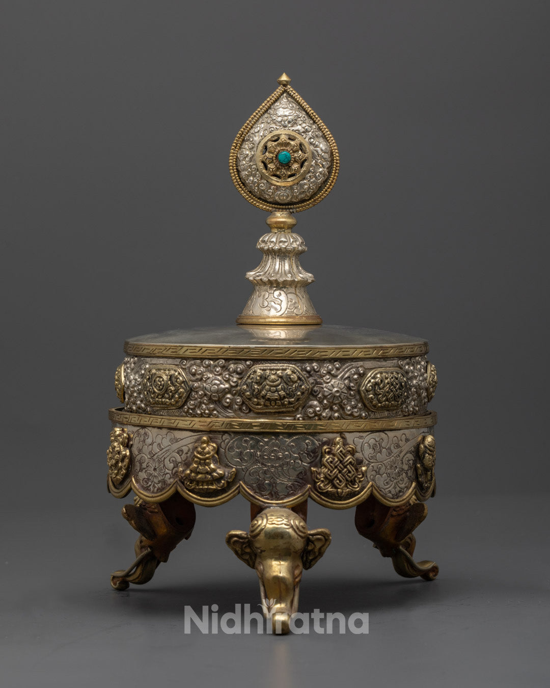 Close-up of semi-precious stones adorning a silver-plated Ratna Mandala