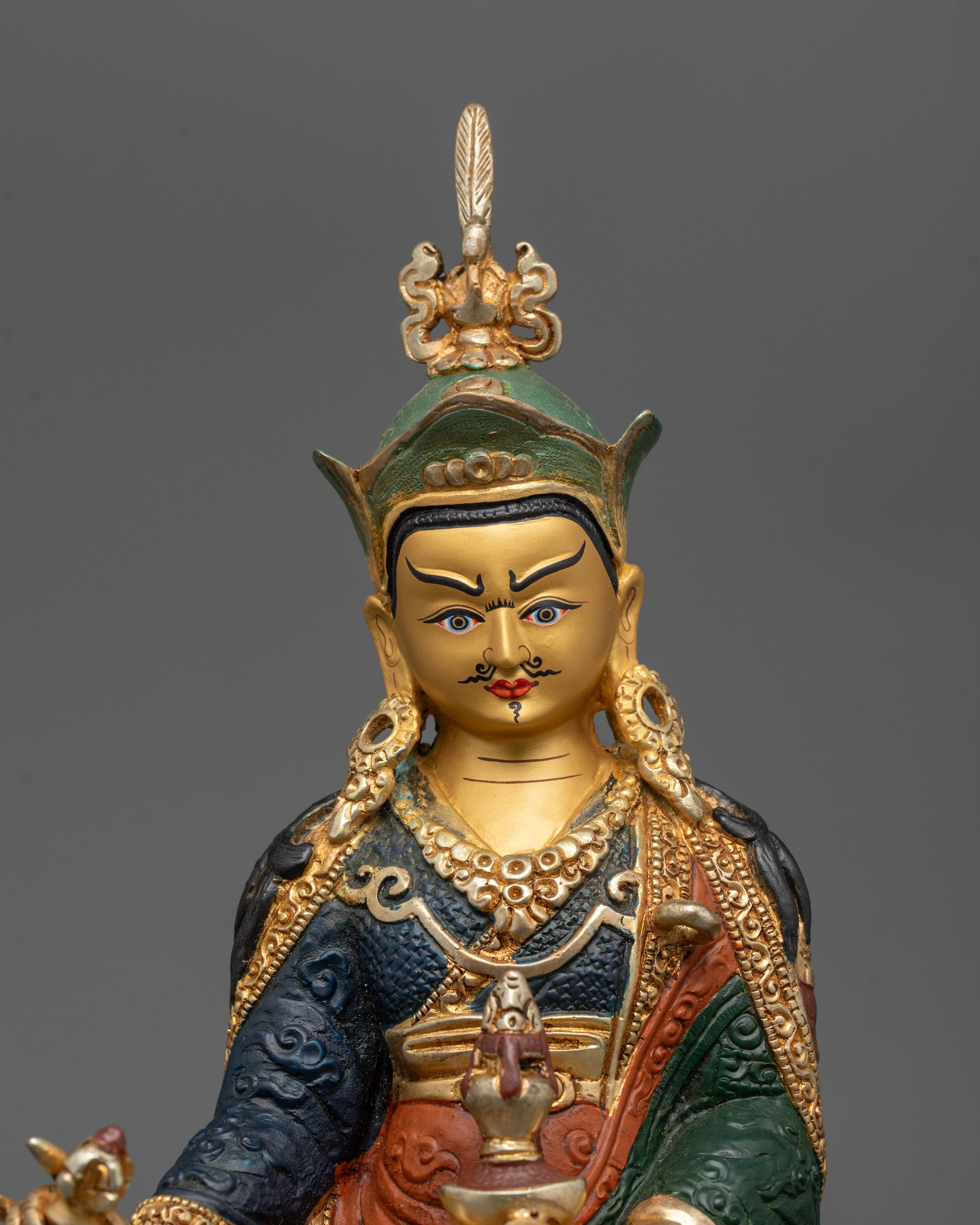 Close-up of semi-wrathful expression and intricate carvings on Painted Padmasambhava Statue