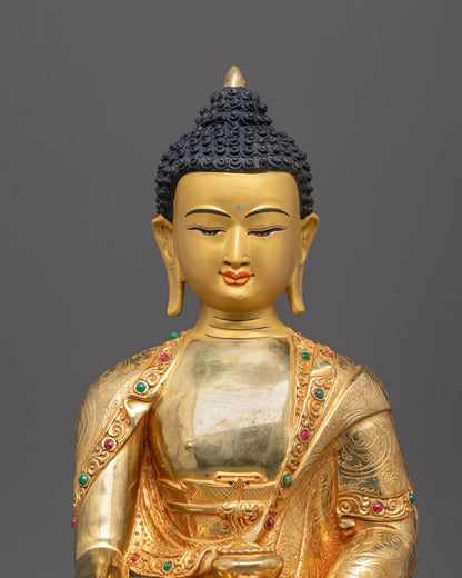 Close-up of serene Shakyamuni Buddha face and detailed gold-plated robes