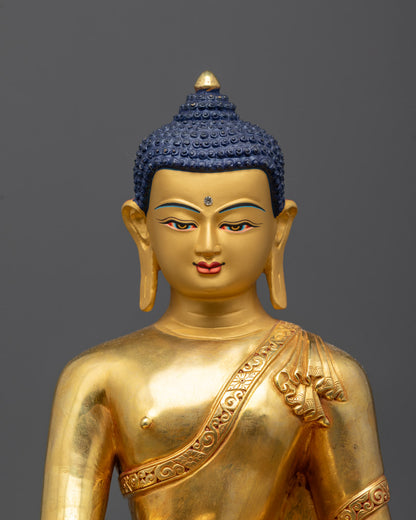 Close-up of serene gold-gilded face of Shakyamuni Buddha, representing wisdom