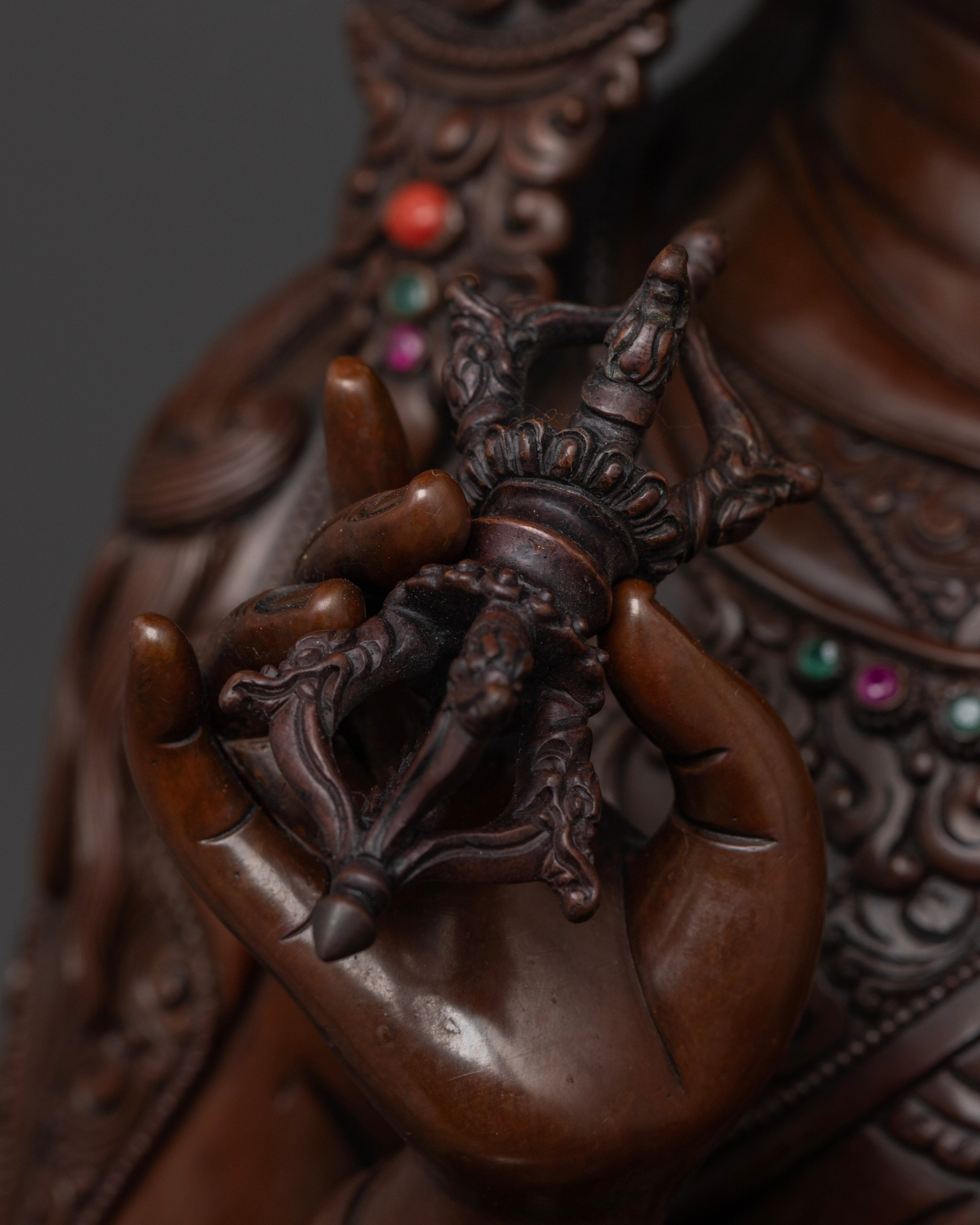 Close-up of the 24k gold face of Guru Rinpoche statue, symbolizing wisdom, protection