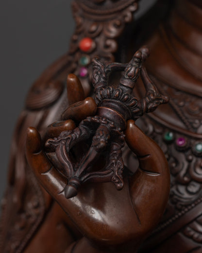 Close-up of the 24k gold face of Guru Rinpoche statue, symbolizing wisdom, protection