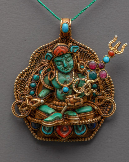 Close-up of turquoise Guru Rinpoche figure with coral-adorned crown and gems
