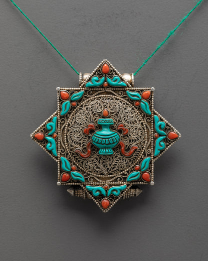 Close-up of turquoise Treasure Vase and intricate silver-plated filigree on handmade Nepalese locket