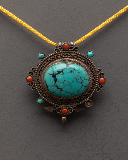 Close-up of turquoise centerpiece on handcrafted Tibetan copper locket pendant