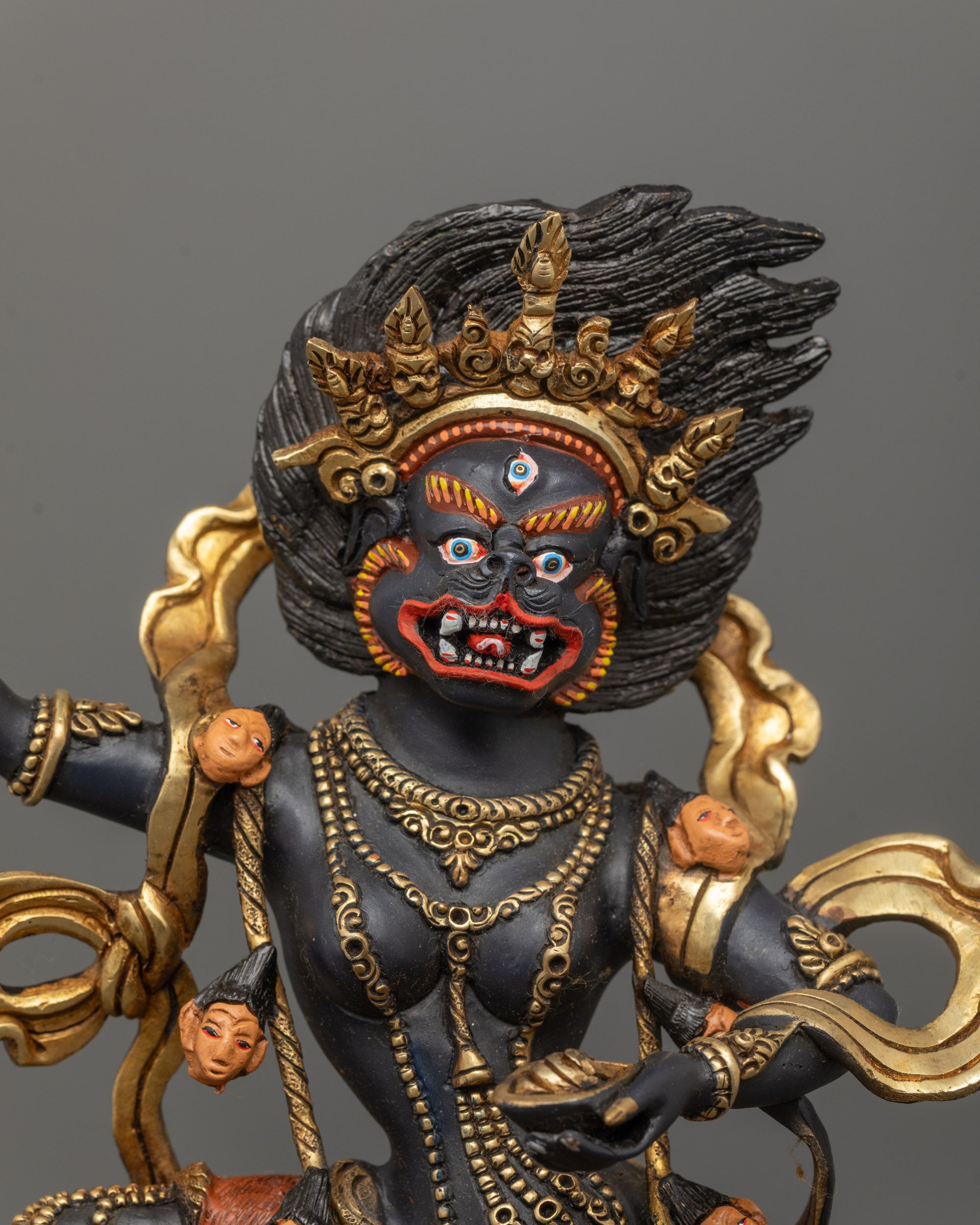 Close-up of wrathful Singha Mukha Statue showing detailed facial expression