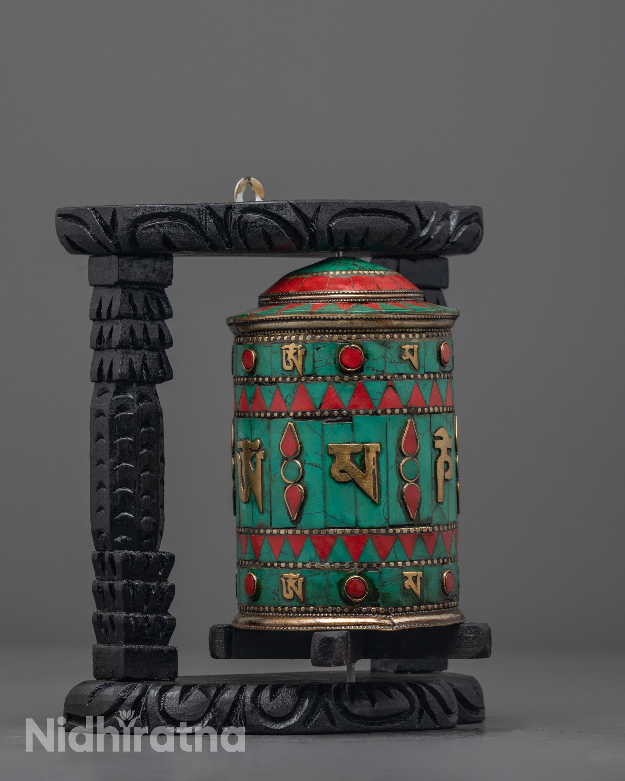 Close-up on stone inlays, highlighting turquoise and coral embedded into the wheel 