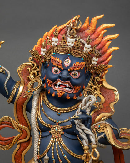 Close-up showing Vajrapani Statue’s fierce gaze, gold-gilded robes, and Vajra in hand