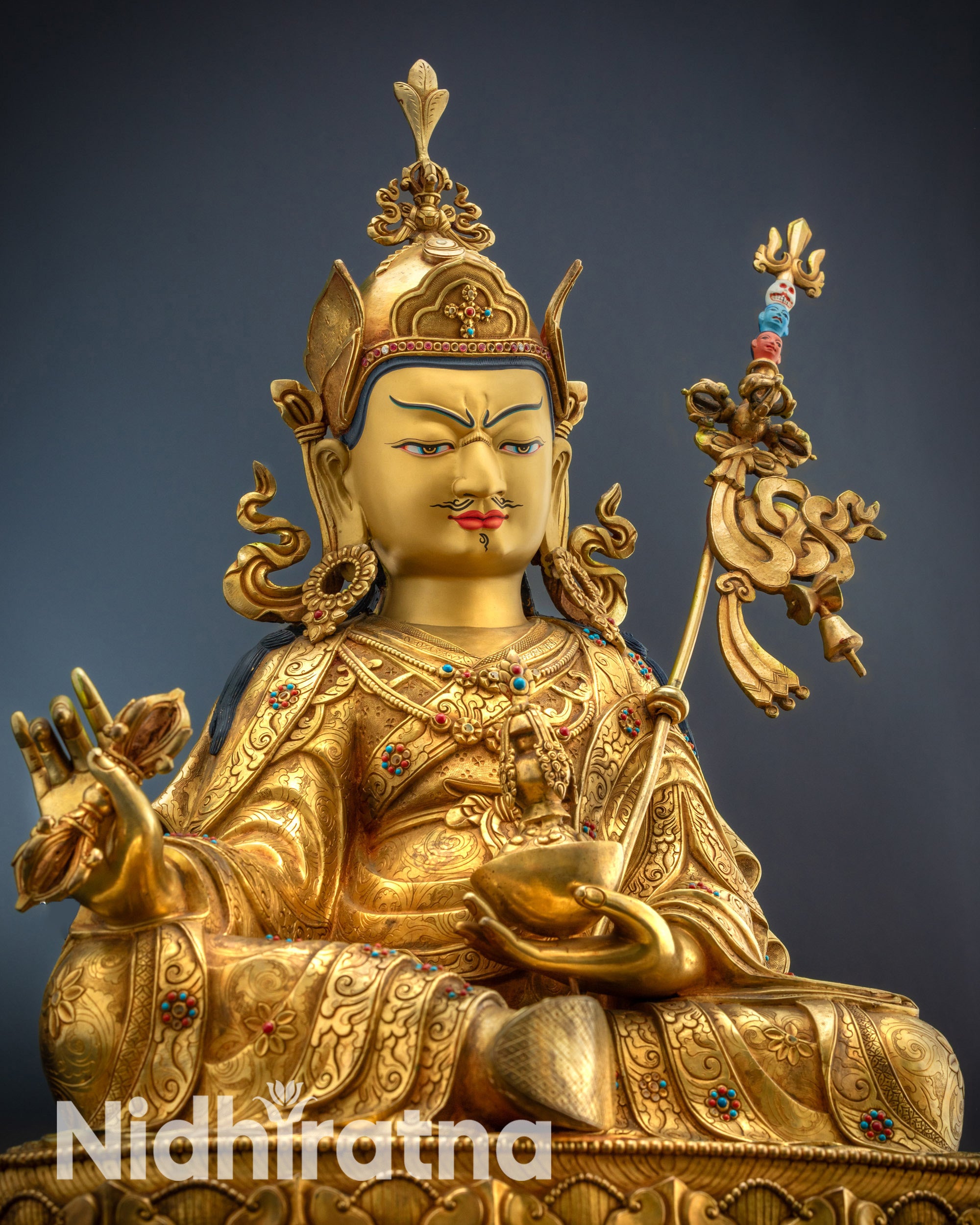 Close-up Lower side view of Guru Padmasambhava statue with lotus hat and five-petal crown