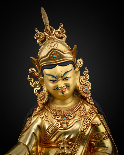 Close-up view of Hand-carved Guru Rinpoche statue with 24k gold gilded face