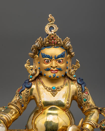 Close-up view of hand-carved Dzambhala Statue with 24k gold gilded detailing