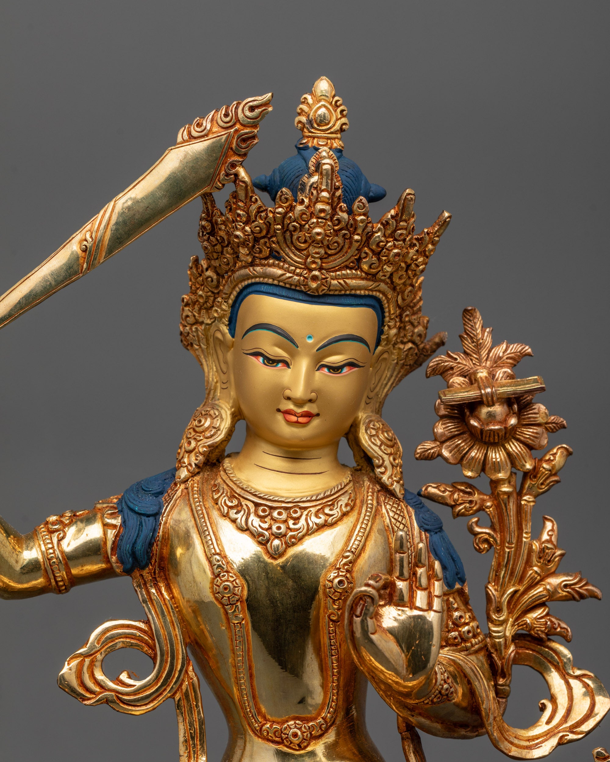Close-up view of hand-carved Manjushri Statue with 24k fire gold gilded details