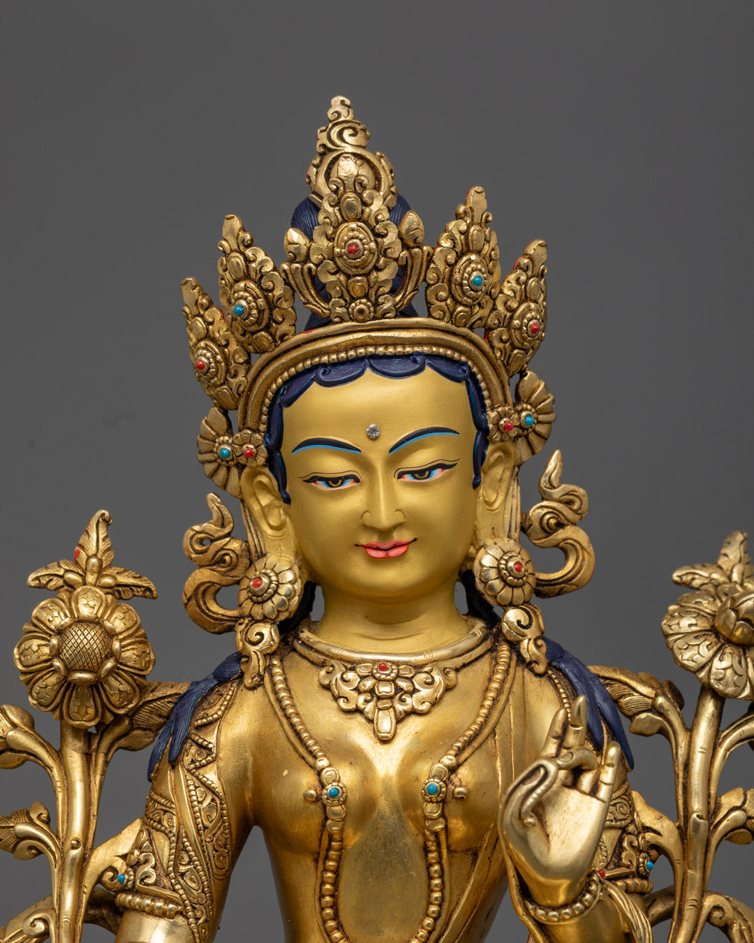 Green Tara Statue showcasing the gold fire-gilded body and intricately crafted face made from precious stones.
