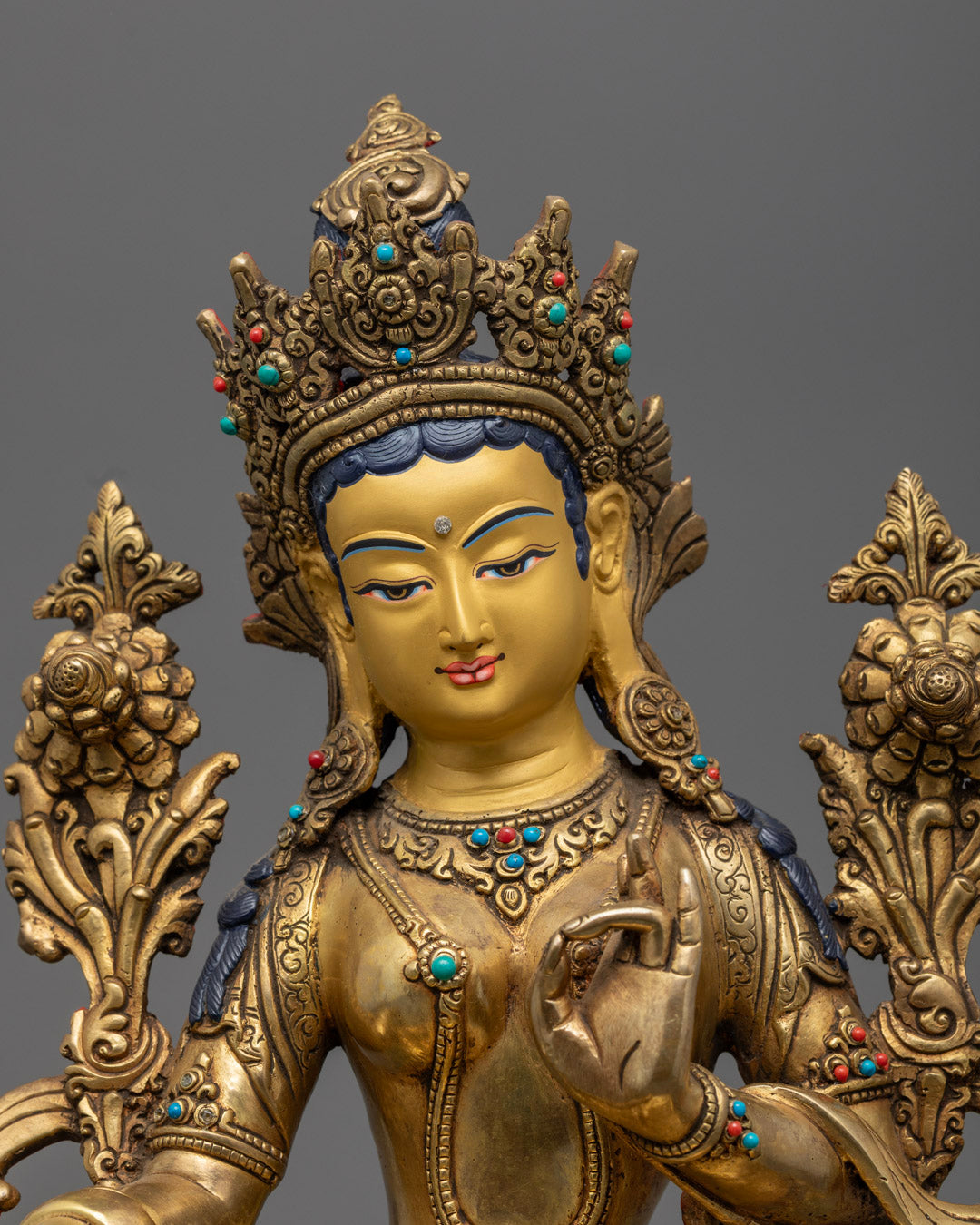 the Green Tara's serene expression and intricate details, showcasing the craftsmanship.