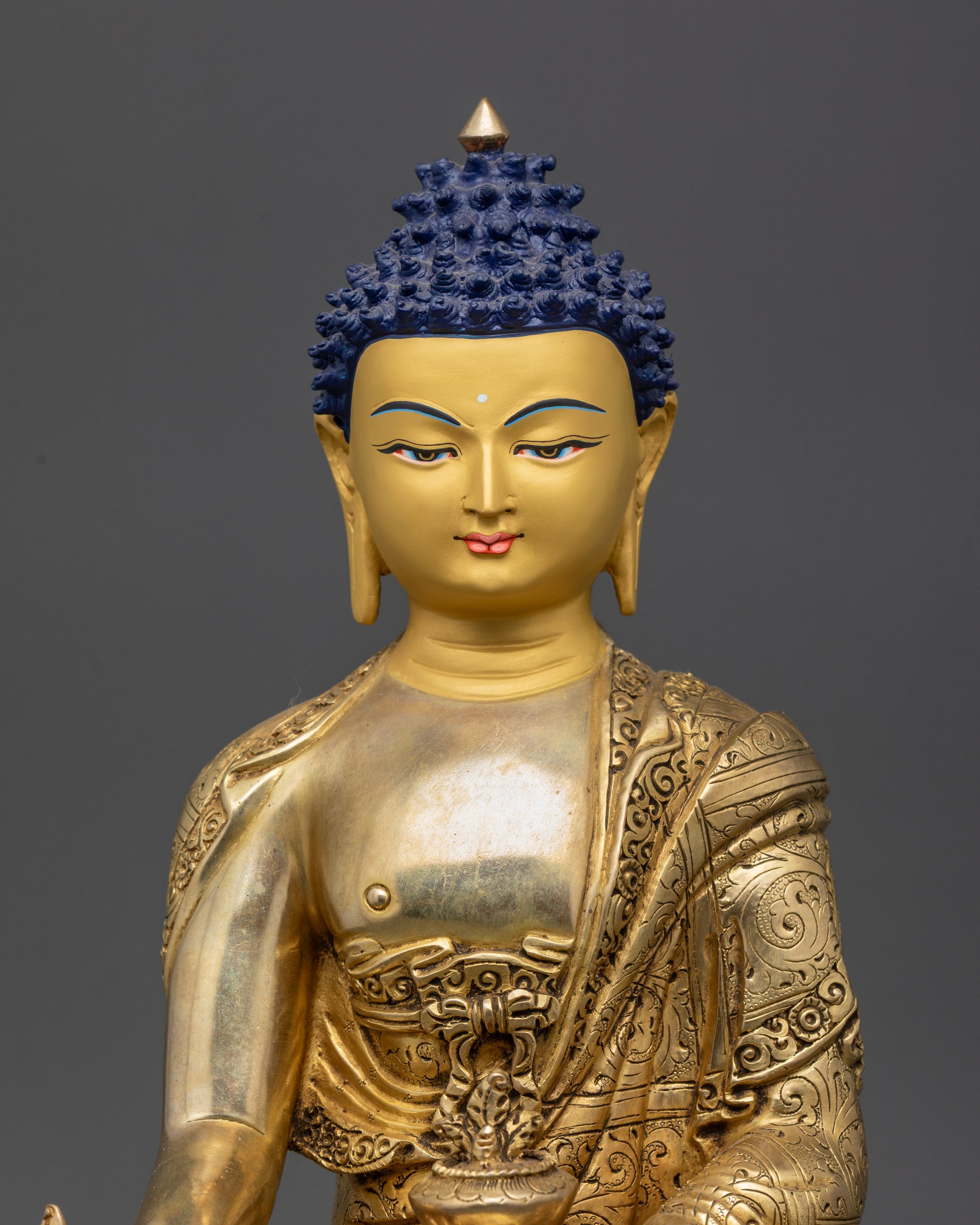 Close View of Gold-Gilded Face and Robe of Bhaisajyaguru Healing Sculpture