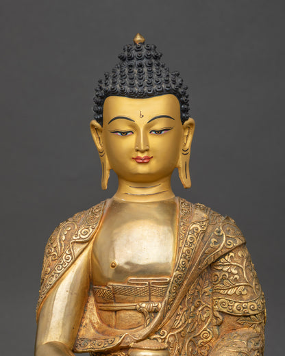Close up Amitabha Buddha face with gold paint, holding alms bowl, handcrafted sacred statue