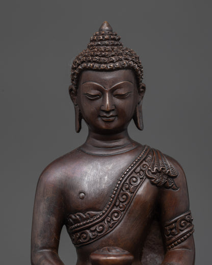 Close up Amitabha Buddha figurine showing oxidized copper details and serene expression
