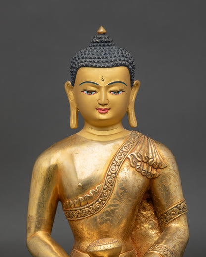 Close up Amitabha Buddha gold-painted face showing serene expression and meditation symbol
