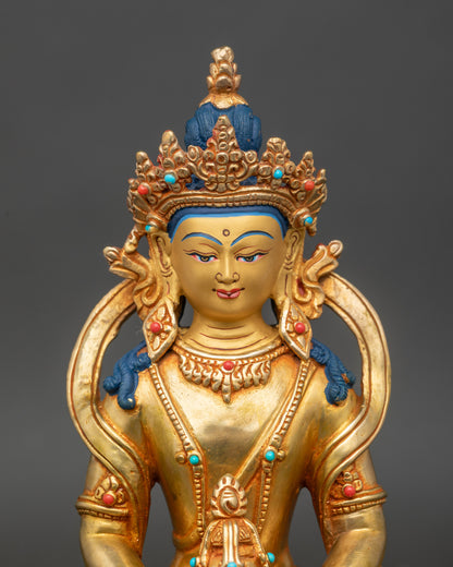 Close up Amitayus Buddha face, gold-painted with semi-precious stones, handcrafted Newari art