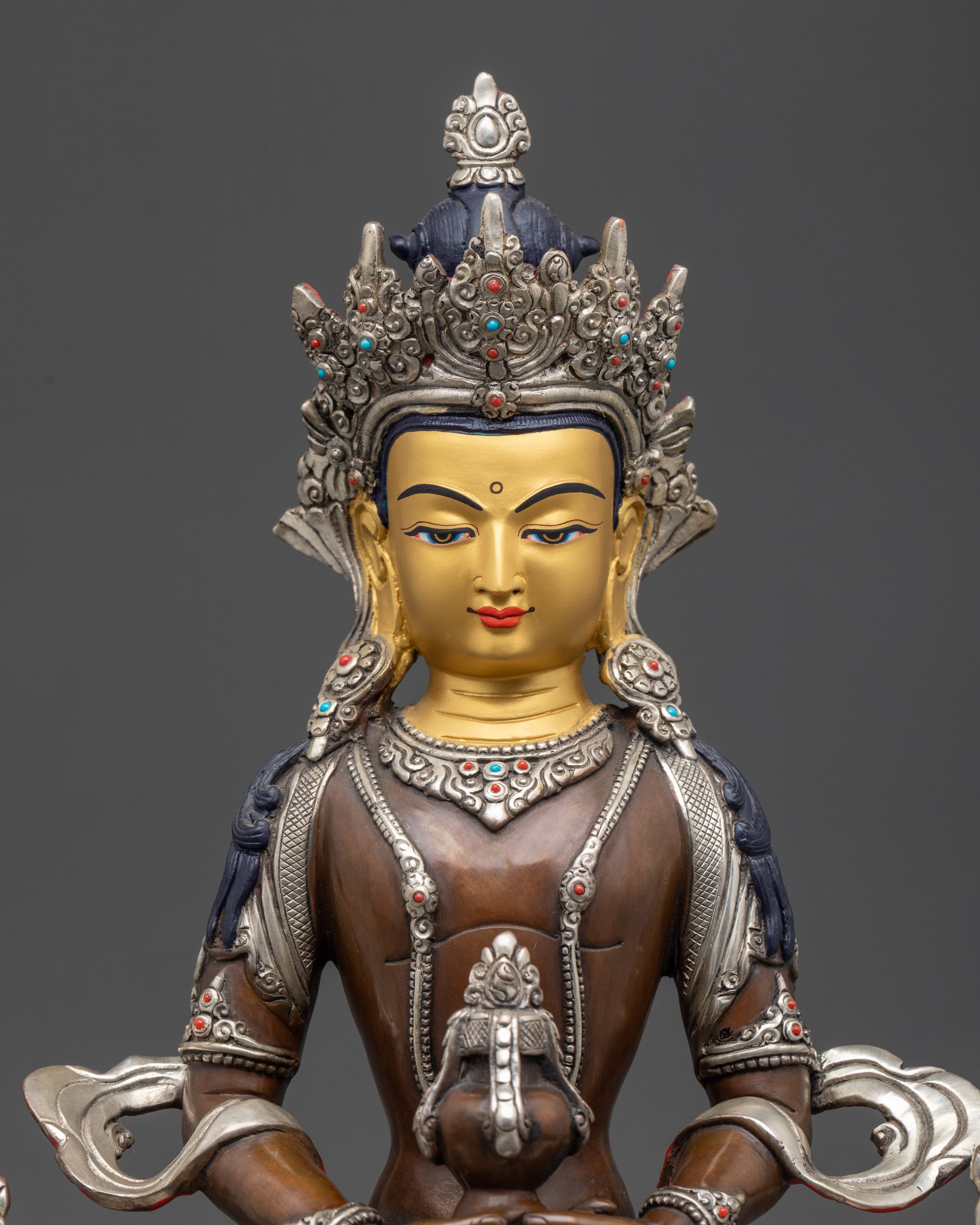 Close up Amitayus Buddha face showing dhyana mudra, gold-gilded face, longevity deity details
