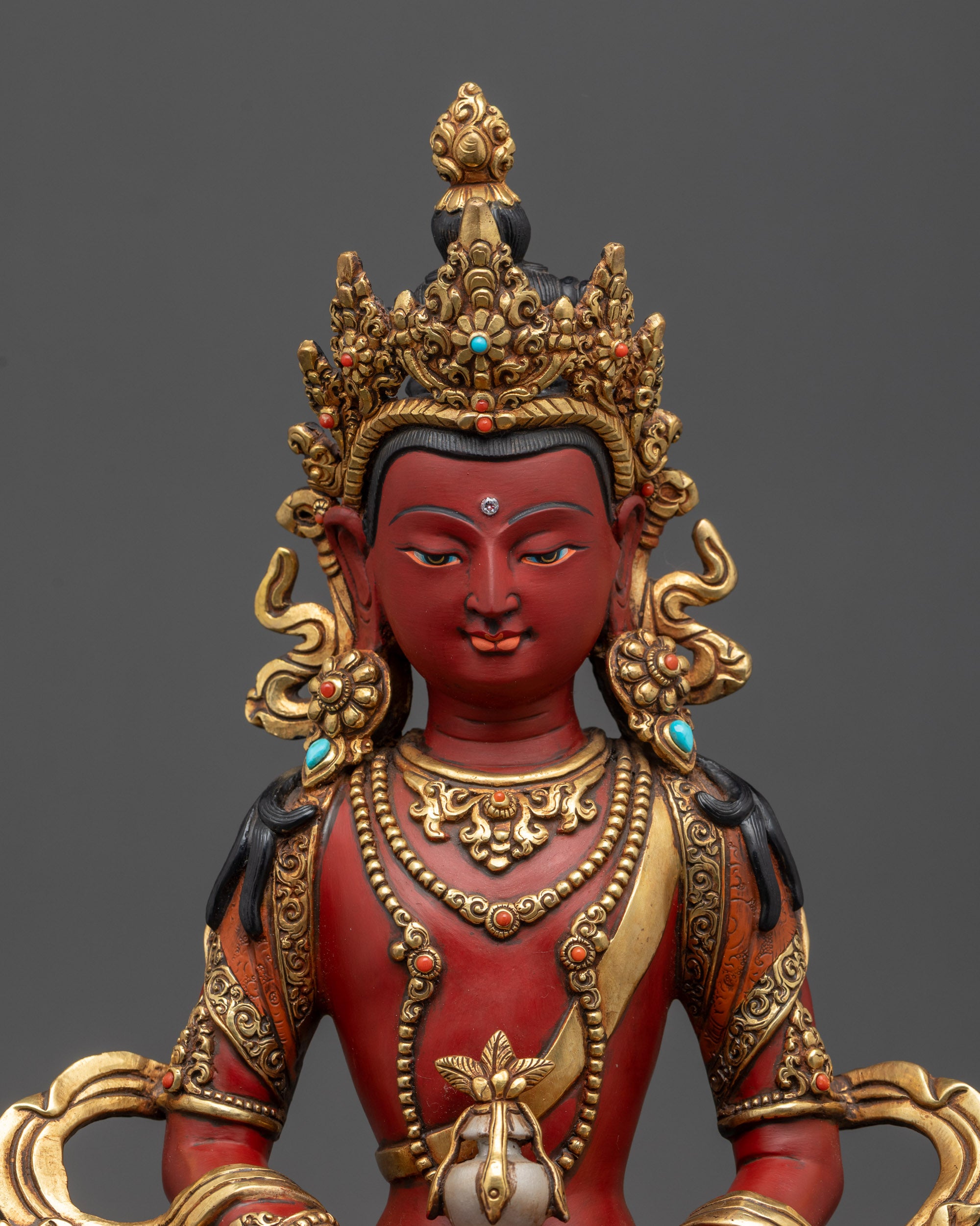Close up Amitayus Buddha face showing majestic expression and jeweled crown