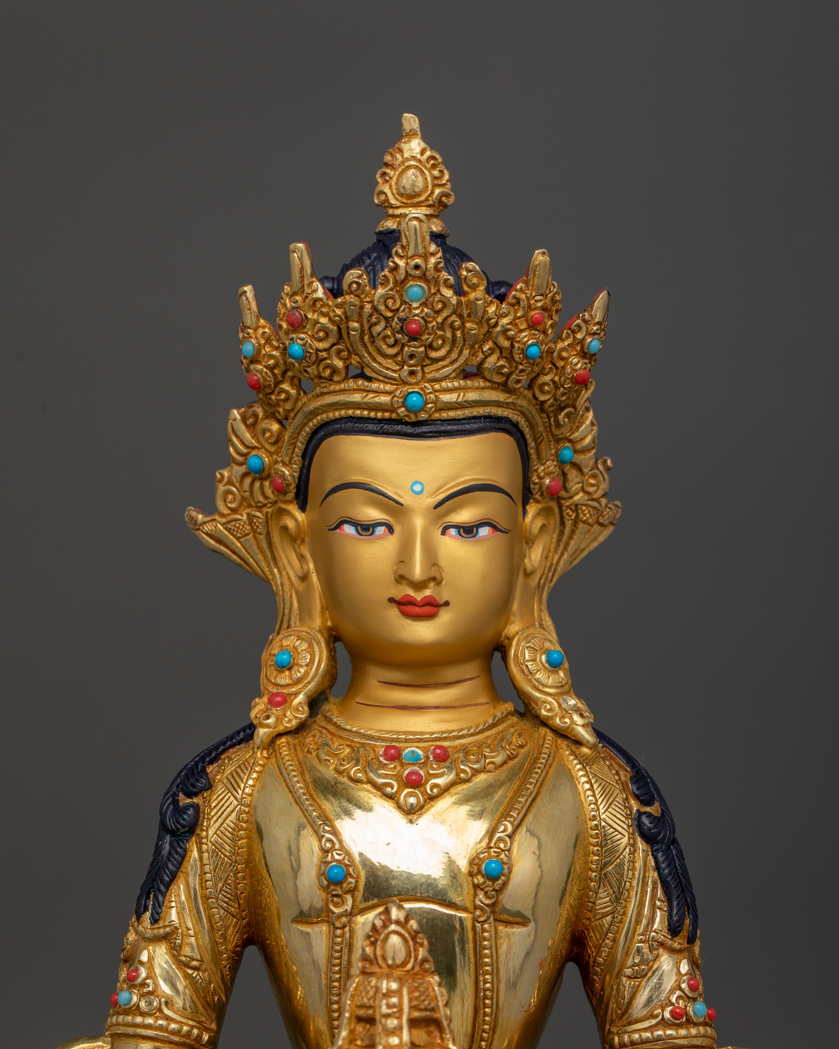 Close up Amitayus statue serene expression semi-precious stones meditation decor