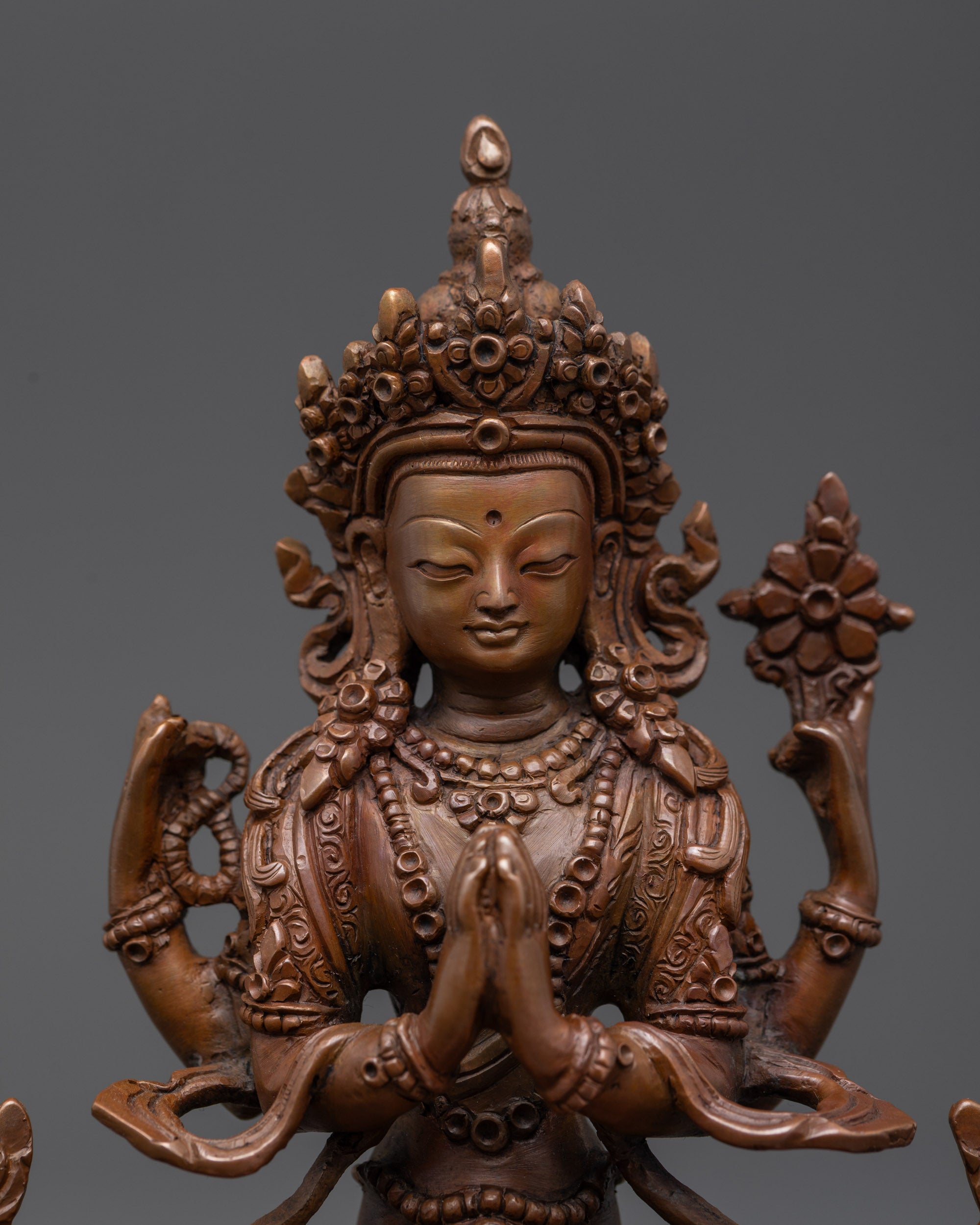 Close up Avalokiteshvara holding Wish-fulfilling gem with intricately carved garments