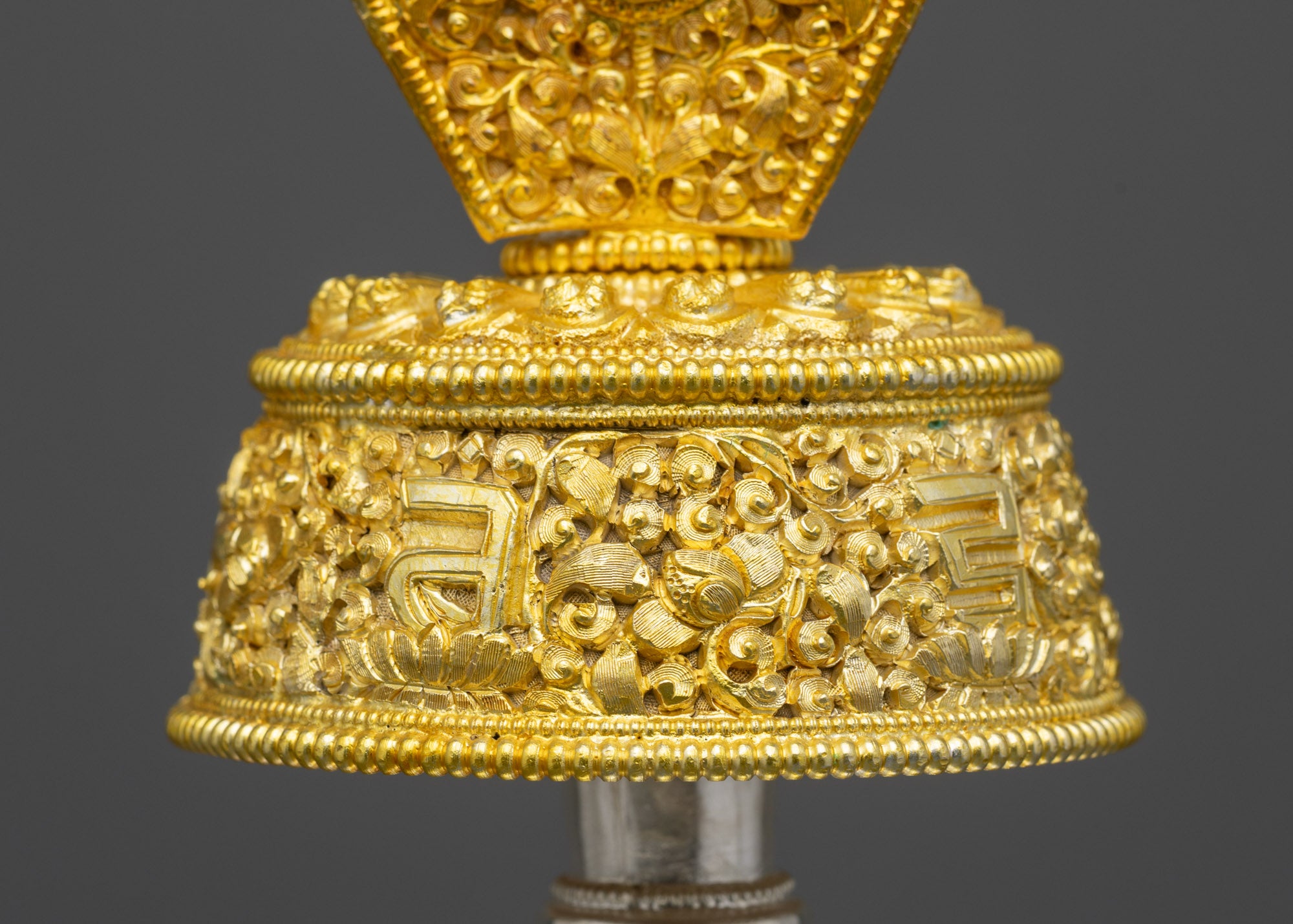 Close up Che Bhumba lid showing sacred mantra and floral motif carvings