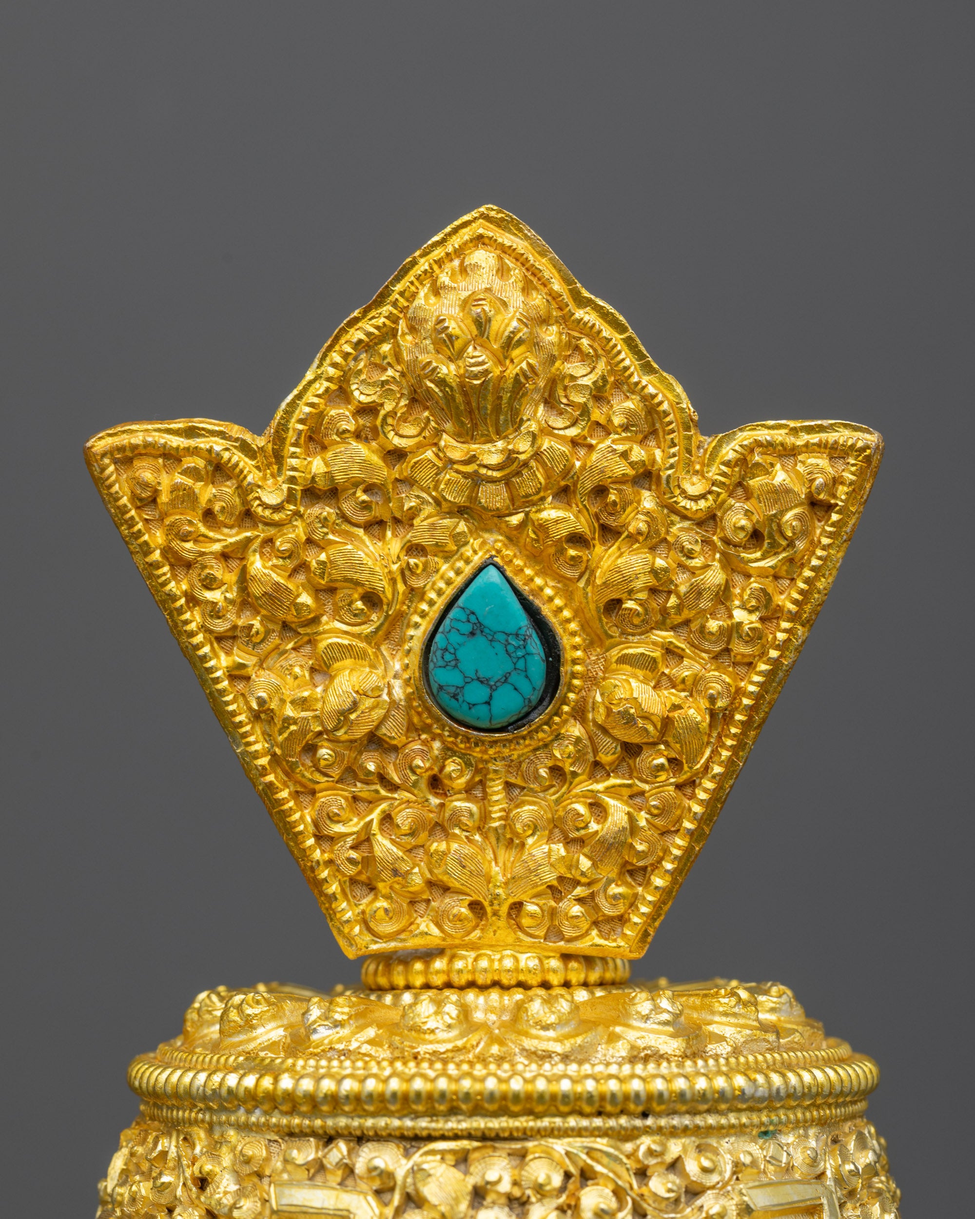 Close up Che Bhumbha lid showing sacred mantra and auspicious motif carvings