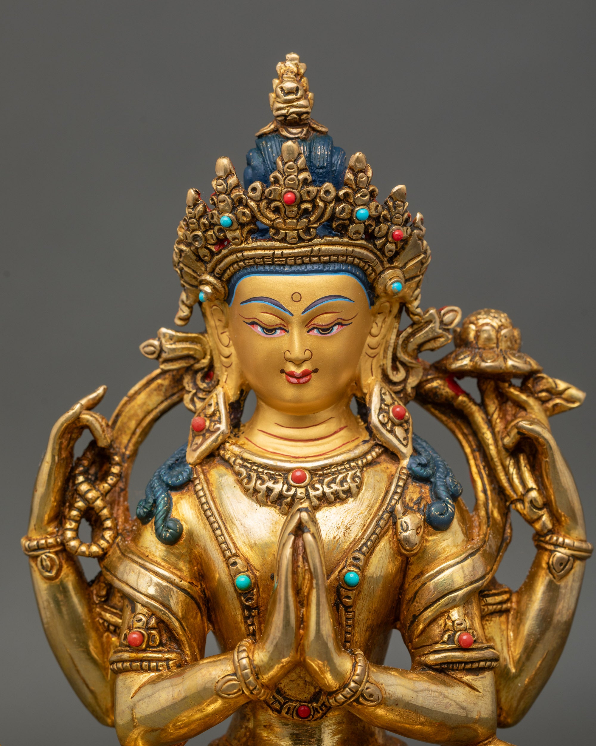 Close up Chenrezig Bodhisattva sculpture adorned with semi-precious stones handmade in Nepal