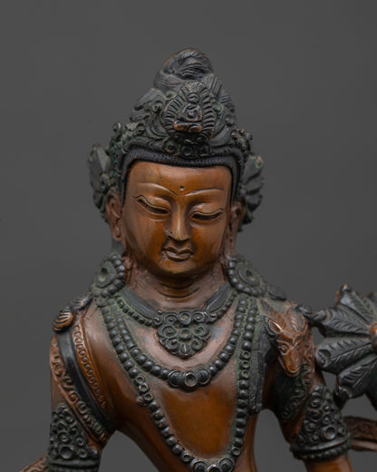 Close up Chenrezig Bodhisattva statue showing calm oxidized copper face and intricate robes