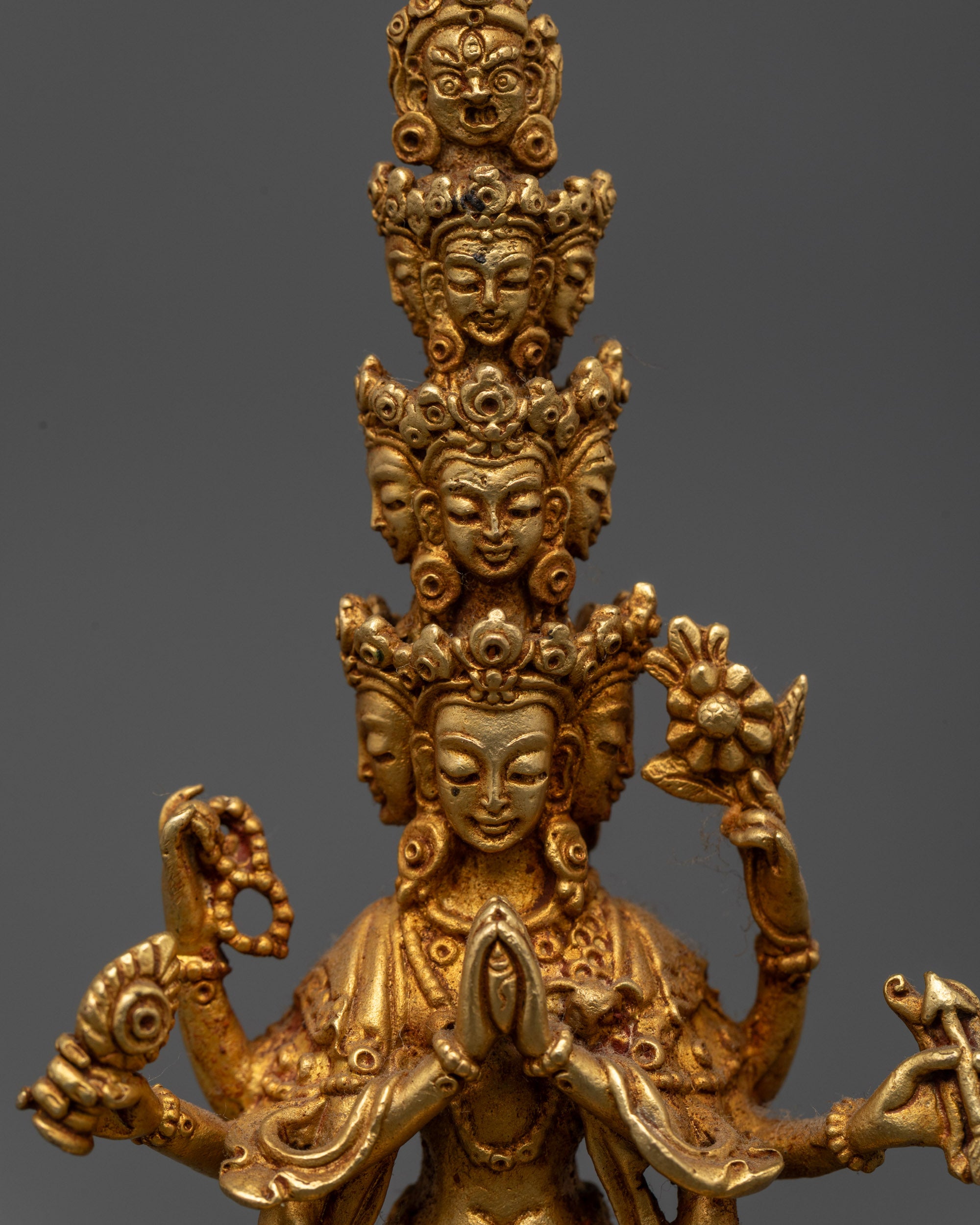 Close up Chenrezig Statue showing 11 faces with unique crowns and intricate halo