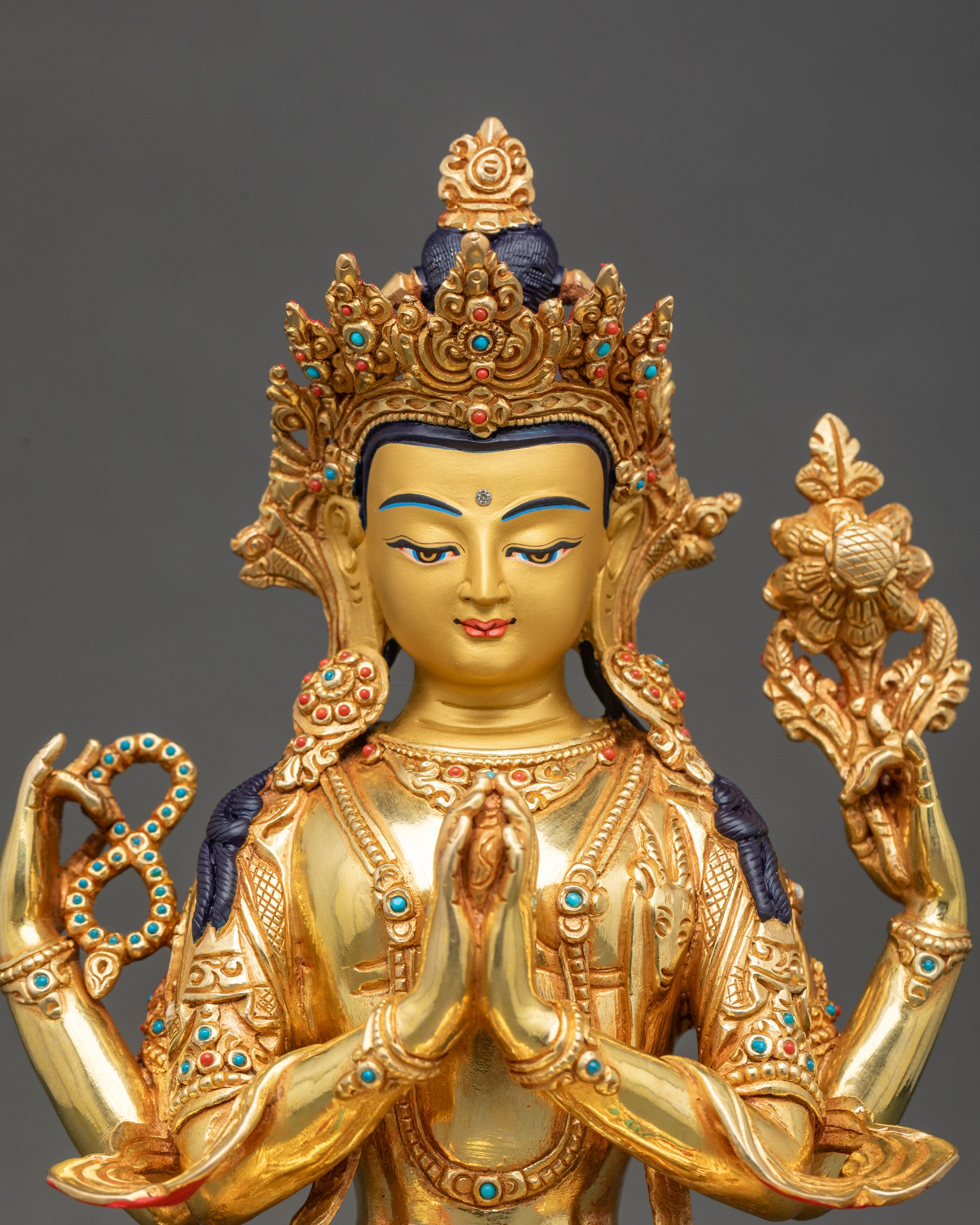 Close up Chenrezig copper statue with crown, jewelry, and sacred objects