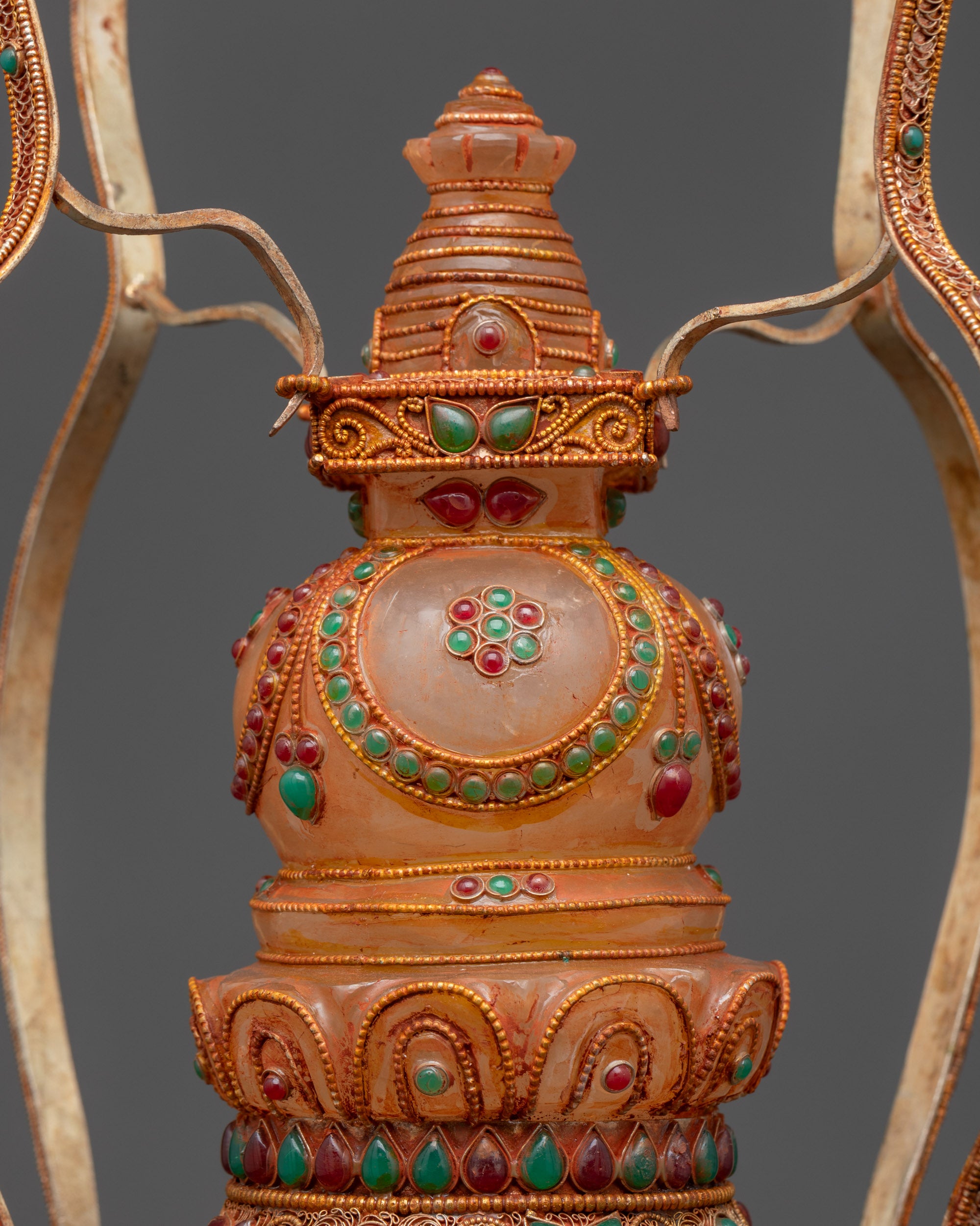 Close up Crystal Core Tibetan Stupa showing crystal center, stone inlay and filigree detail