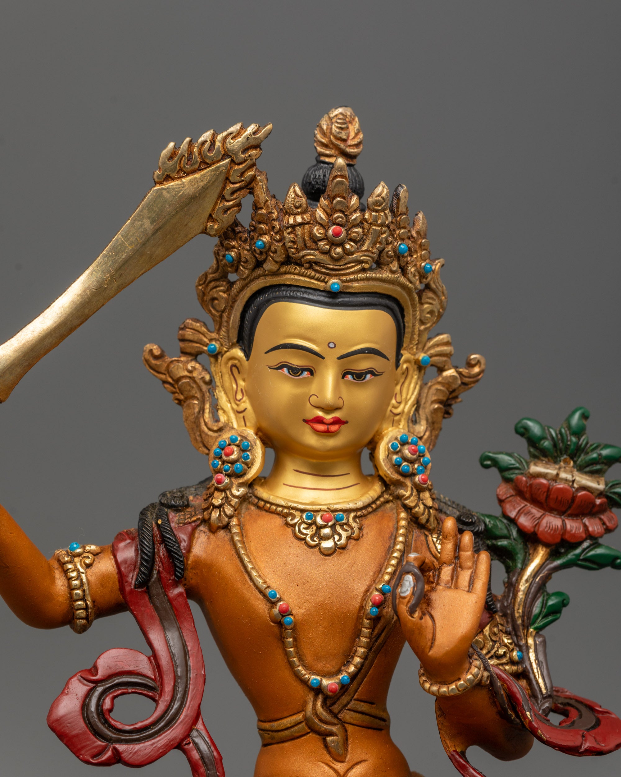 Close up Detailed view of Manjushri Statue holding sword and utpala flower