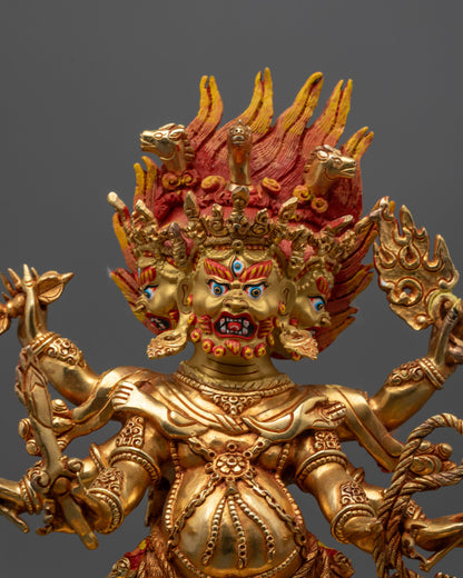 Close up Dharmapala Statue showing intricate details and multiple arms wielding sacred objects
