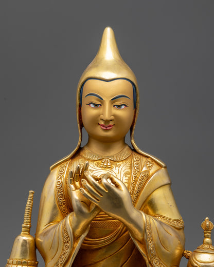 Close up Dipankara Atisha gold-gilded face and detailed monk’s robe patterns