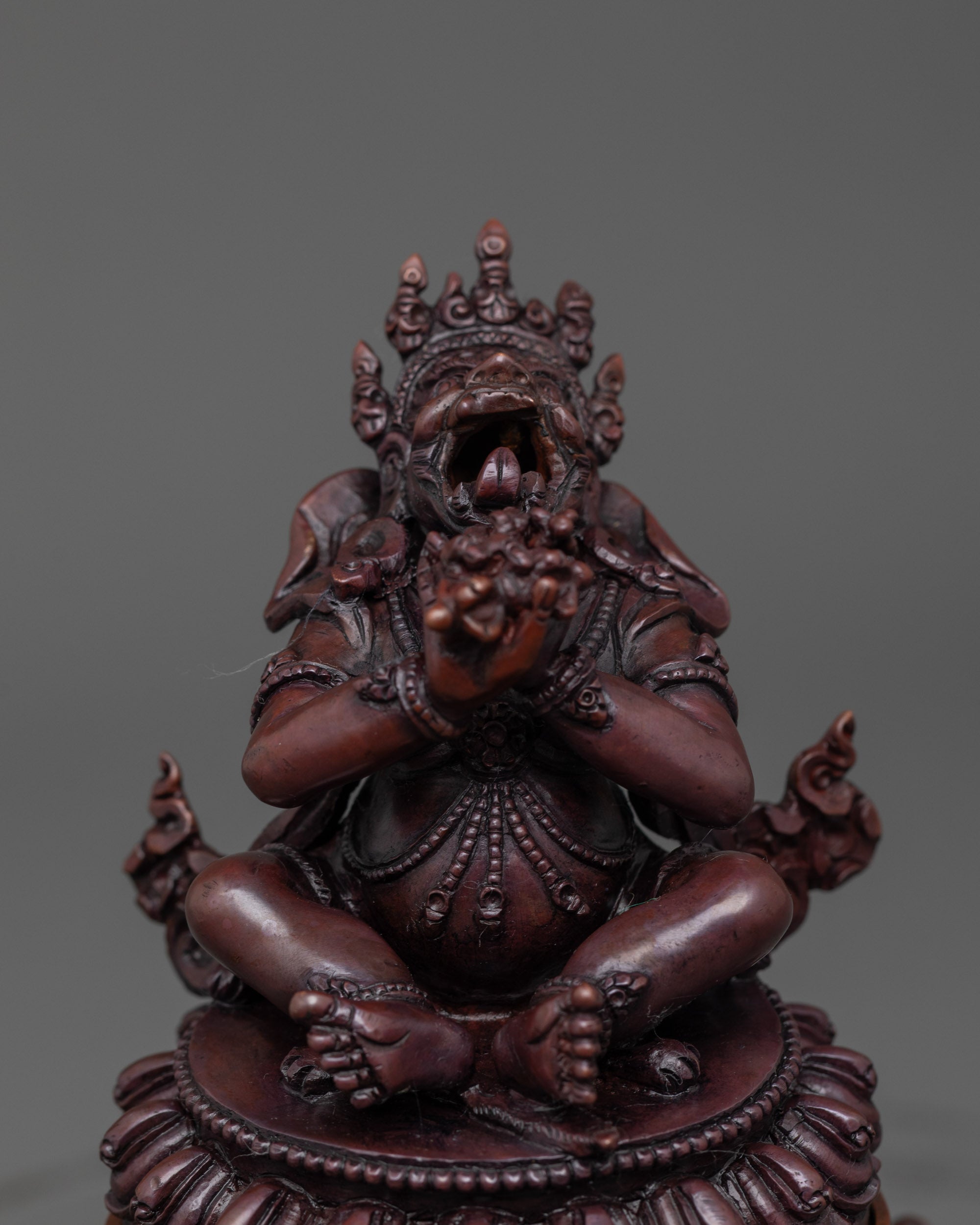 Close up Dorje Khadro face with fierce expression and oxidized copper detailing

