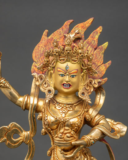 Close up Dorje Phagmo gold-gilded face with skull garland and ritual implements