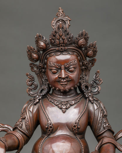 Close up Dzambhala Buddha sculpture with crown and ornate jewelry, handmade in Patan, Nepal