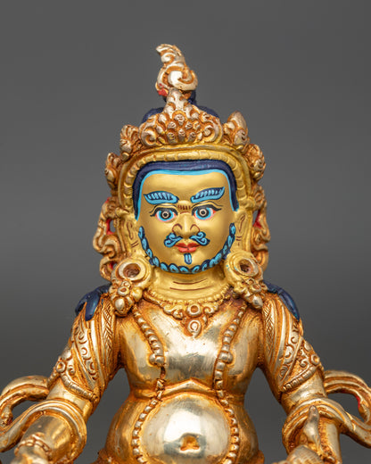 Close up Dzambhala statue gold-painted face hand-painted colors Newari craftsmanship