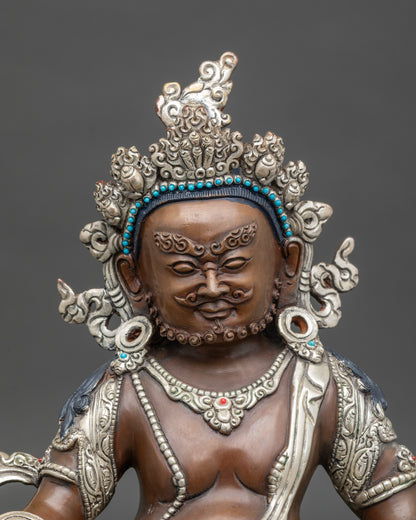 Close up Dzambhala wealth deity statue with semi-precious stones, oxidized silver-plated copper detail