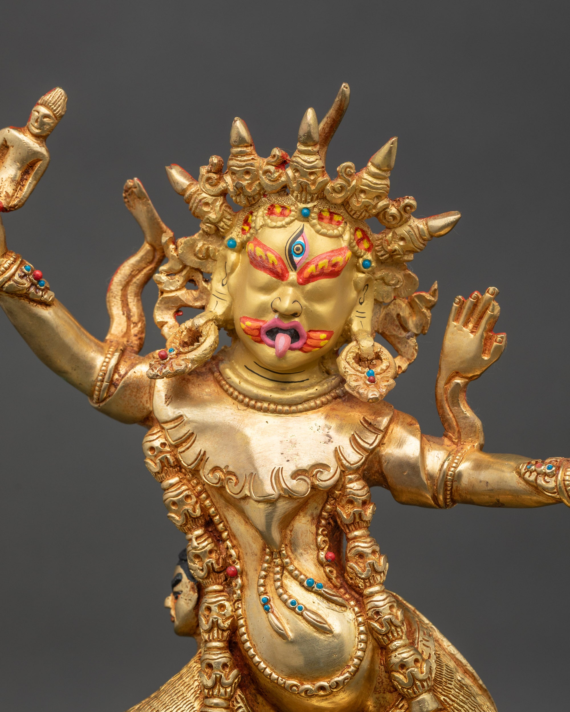 Close up Ekajati statue single eye five-skull crown flaming halo gold-painted face