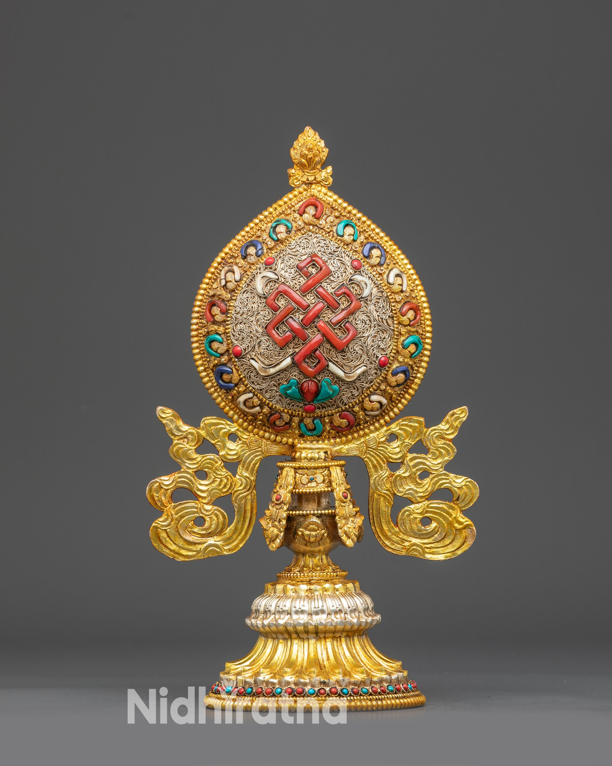 Close up Endless Knot (Shrivatsa) from Ashtamangala set, copper with stones and filigree