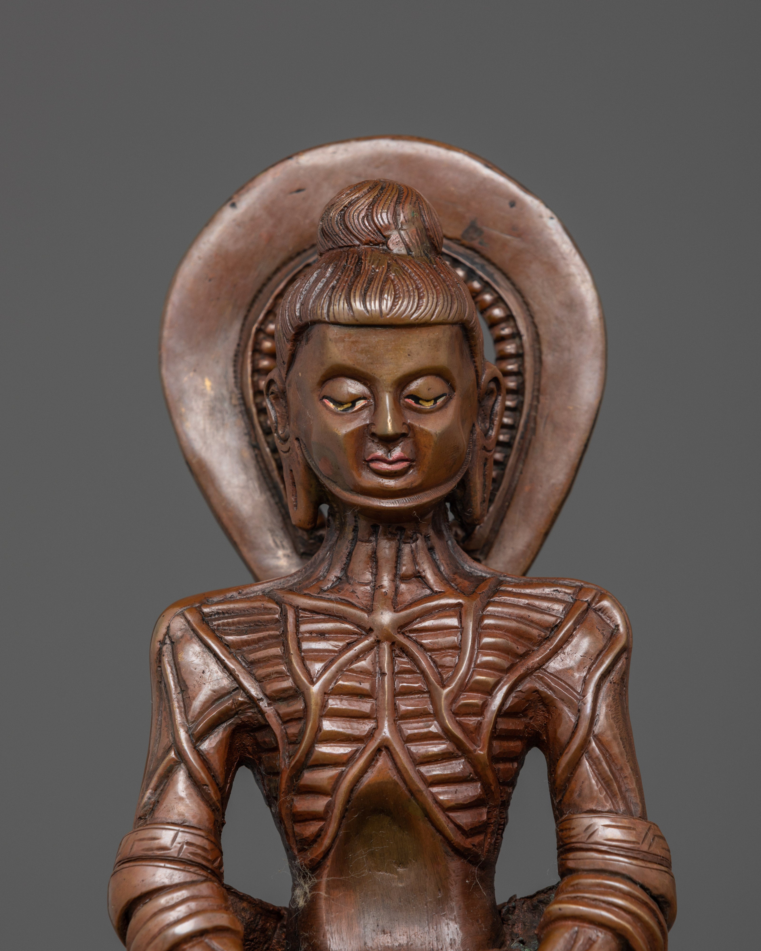 Close up Fasting Buddha gaunt form round halo meditative posture Himalayan sculpture