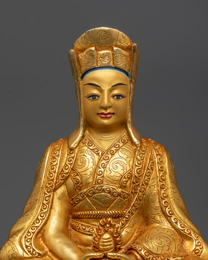 Close up Gampopa Statue showing gold gilded face and cintamani wish fulfilling jewel
