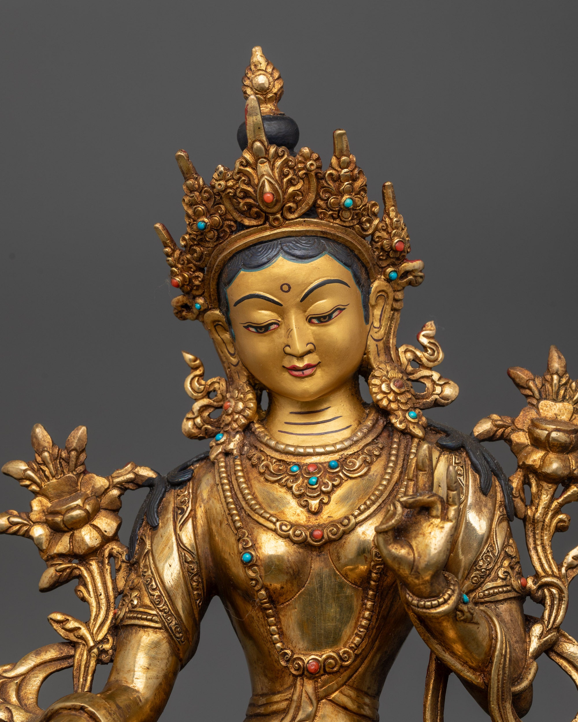 Close up Green Tara Statue showing intricate carvings and semi-precious stone details
