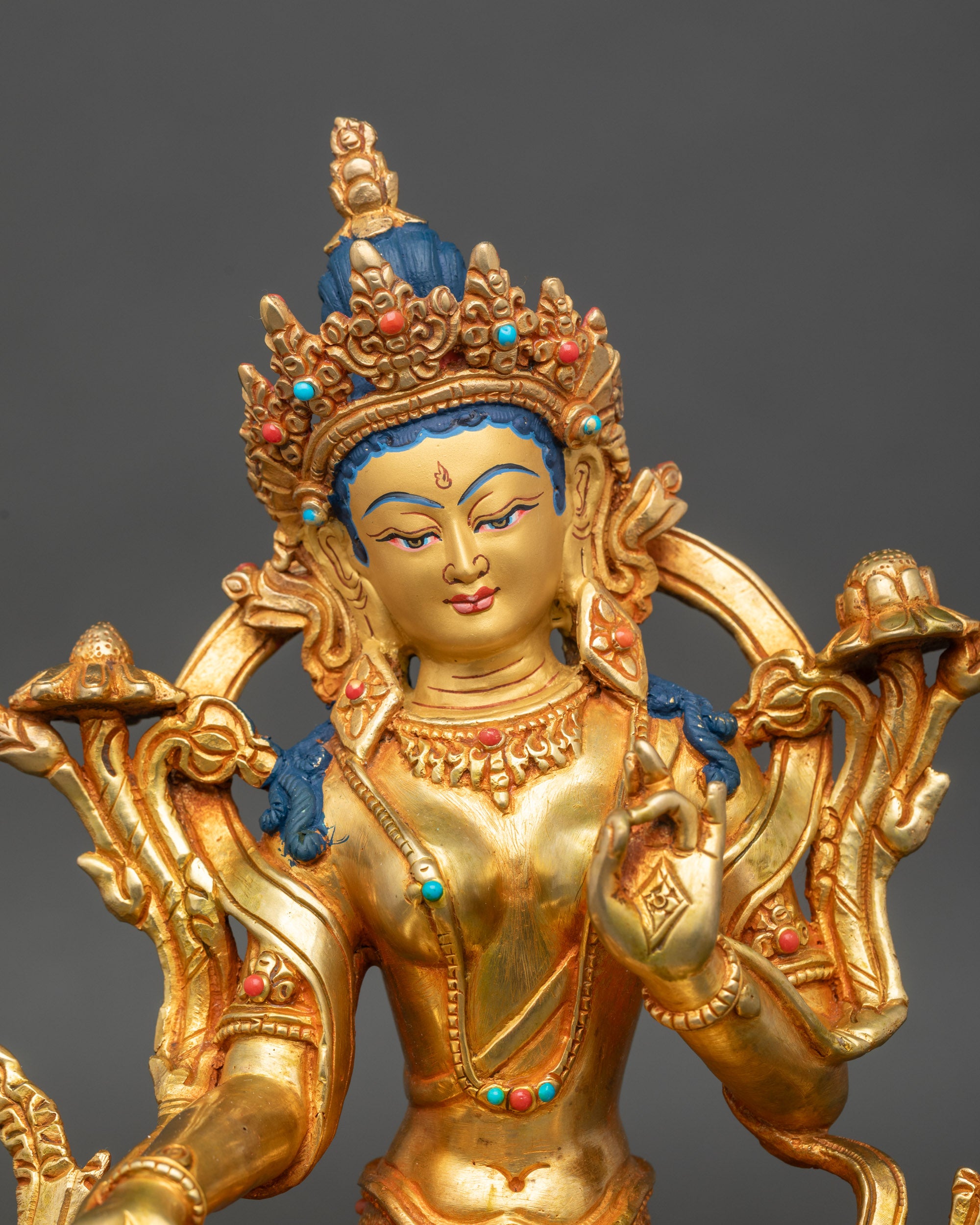 Close up Green Tara face gold-painted, coral and turquoise stones, handcrafted Newari art